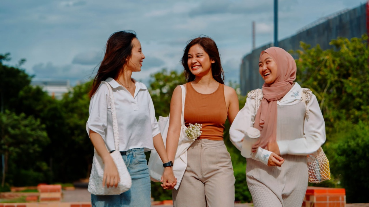 what to wear in malaysia for female three yound woman from different culture smiling together